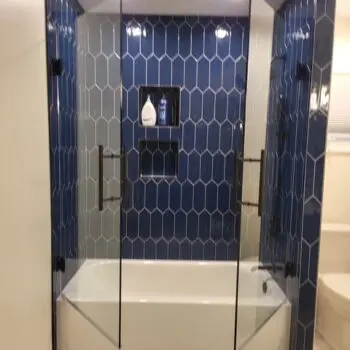 Glass shower door blue tiles