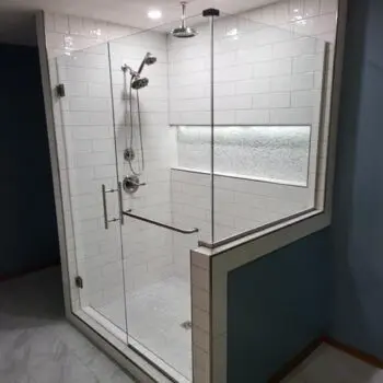 Glass shower with white tiles