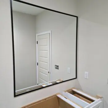 Bathroom mirror above empty vanity