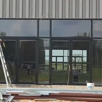 Person installing large glass window