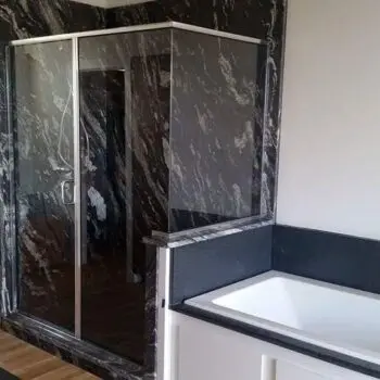 Glass shower enclosure with bathtub