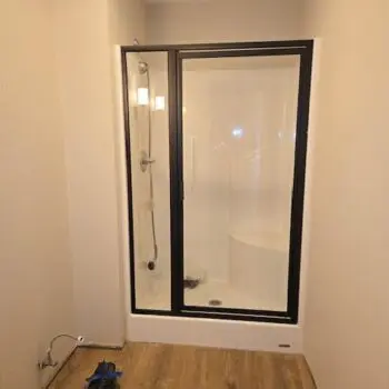 Glass shower door wooden floor