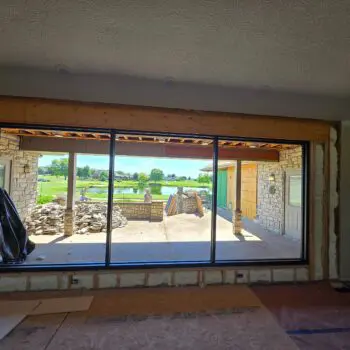 Large window overlooking outdoor patio