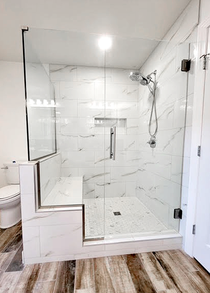 Glass shower enclosure with tile